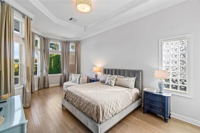 a bedroom with a large bed and a window