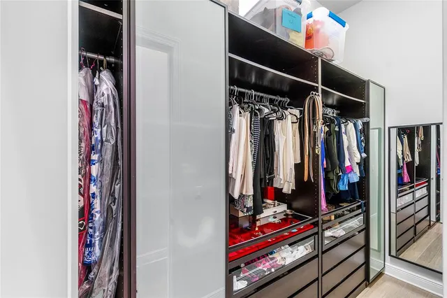 a view of walk in closet with clothes