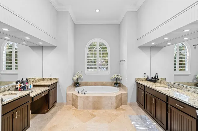 a spacious bathroom with a granite countertop tub sink and mirror