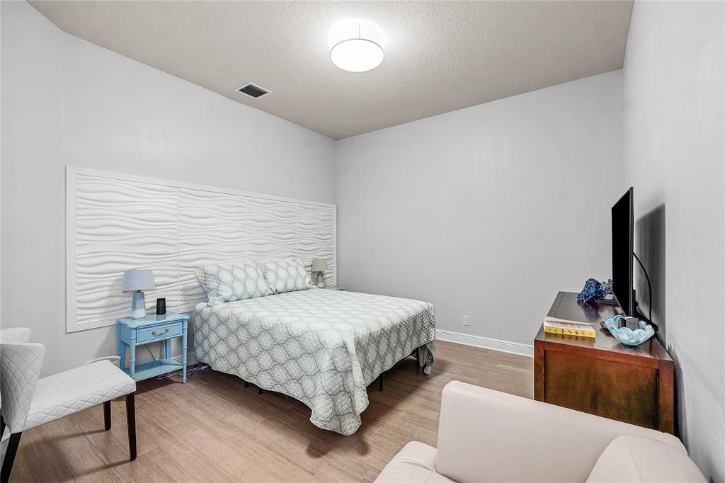 6375 Bellamalfi Street Boca Raton, FL 33496 - Photo 20 of 25 a bedroom with a bed and a chair