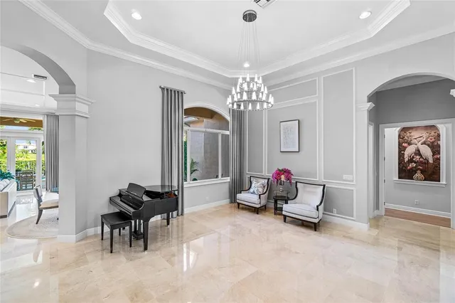 a living room with furniture and a chandelier