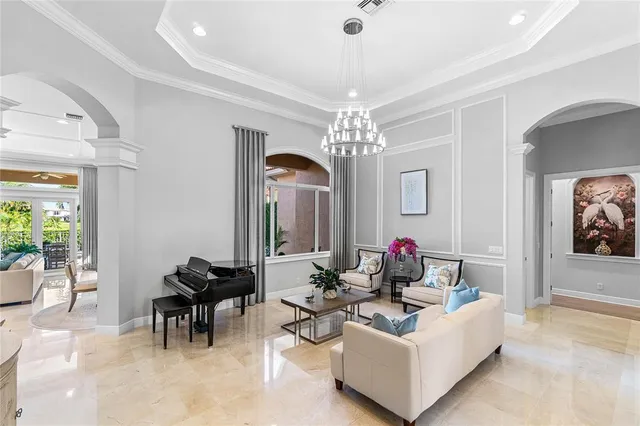 a living room with furniture and a chandelier