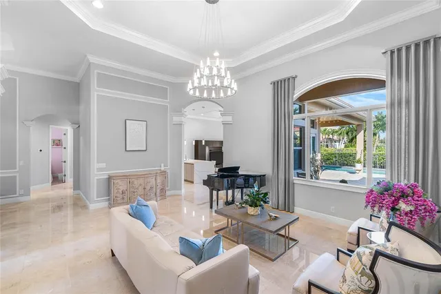 a living room with furniture and a chandelier