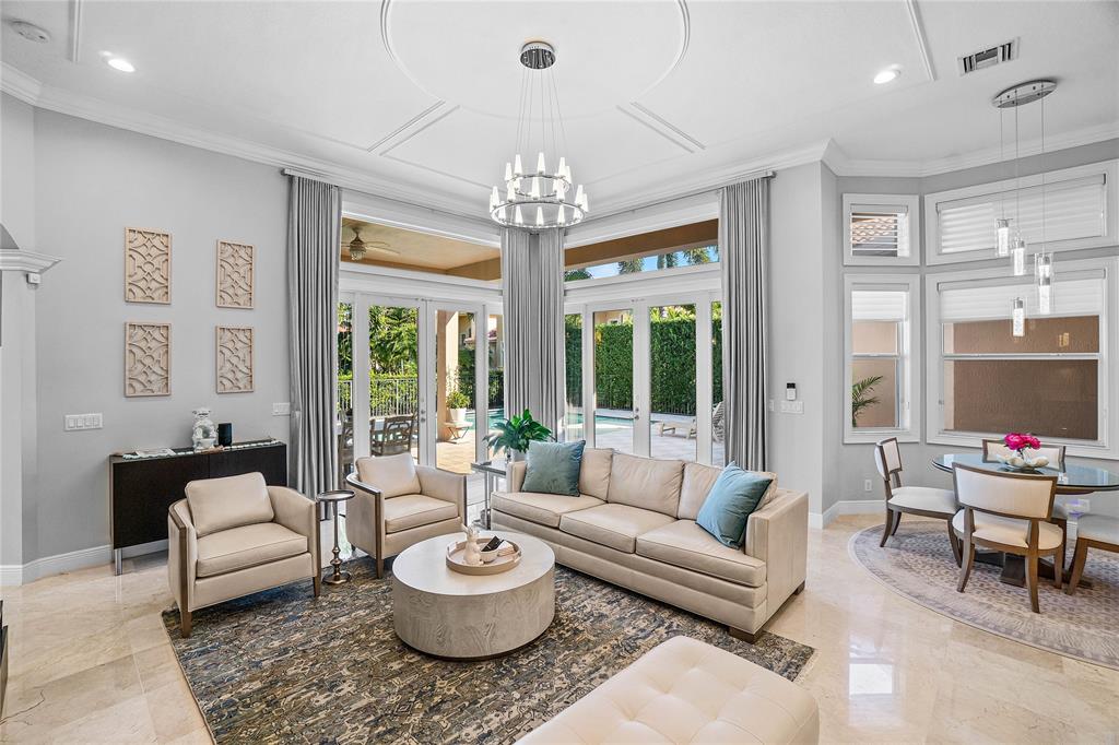 6375 Bellamalfi Street Boca Raton, FL 33496 - Photo 8 of 25 a living room with furniture and a chandelier