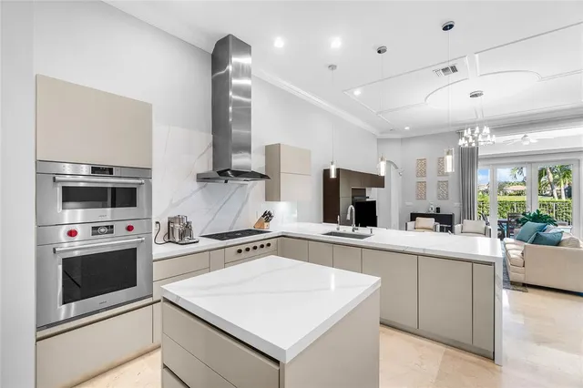 a kitchen with a sink a stove and oven