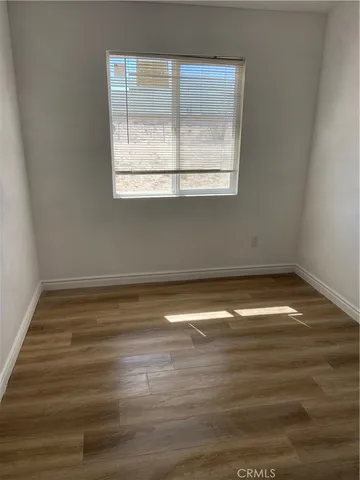 an empty room with wooden floor