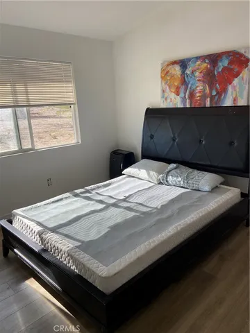 a open kitchen with stainless steel appliances kitchen island granite countertop a table chairs and a refrigerator