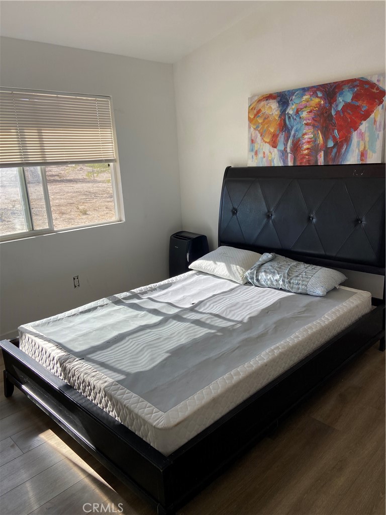 69626 Brant Cross Road Twentynine Palms, CA 92277 - Photo 15 of 33 a bedroom with a bed and window