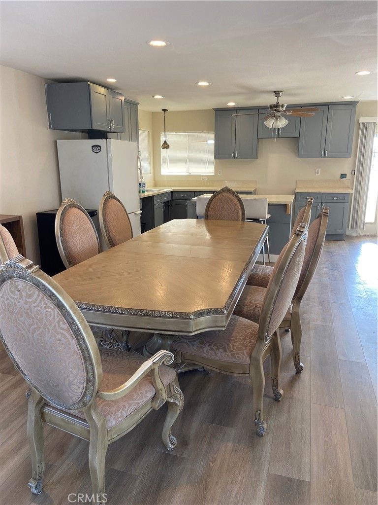 69626 Brant Cross Road Twentynine Palms, CA 92277 - Photo 16 of 33 a open kitchen with stainless steel appliances kitchen island granite countertop a table chairs and a refrigerator