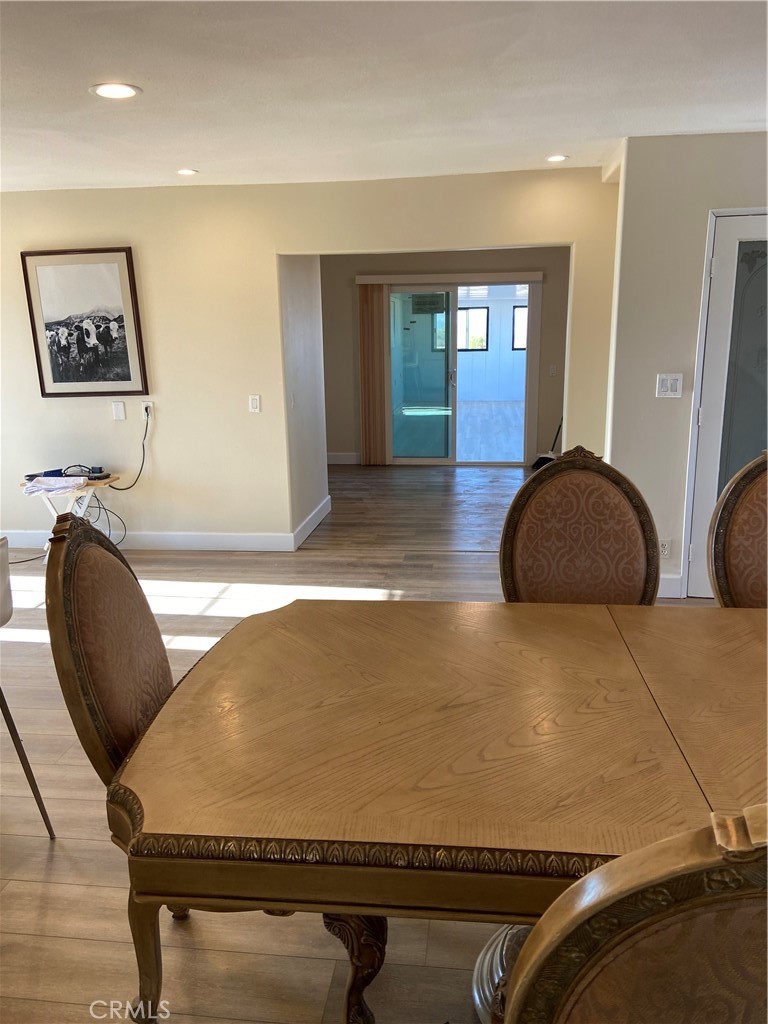 69626 Brant Cross Road Twentynine Palms, CA 92277 - Photo 18 of 33 a room with table chairs and paintings on the wall