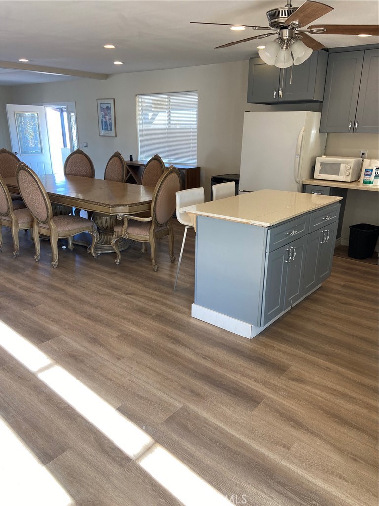 69626 Brant Cross Road Twentynine Palms, CA 92277 - Photo 20 of 33 a living room with stainless steel appliances kitchen island granite countertop a sink dishwasher stove a dining table and chairs with wooden floor