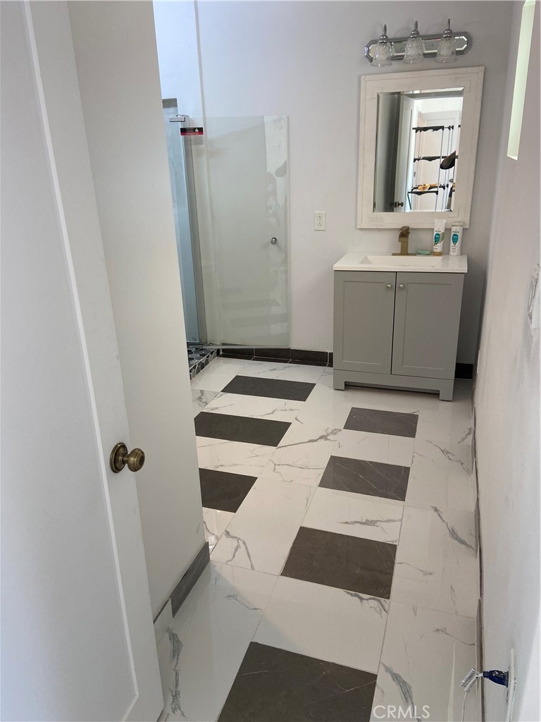 69626 Brant Cross Road Twentynine Palms, CA 92277 - Photo 24 of 33 a bathroom with a sink a toilet a mirror and shower