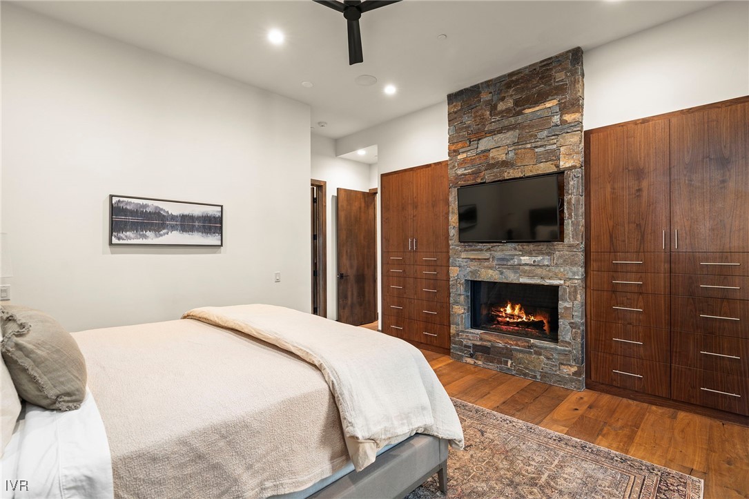 823 Ellen Court Incline Village, NV 89451 - Photo 23 of 45 a spacious bedroom with a bed and a fireplace