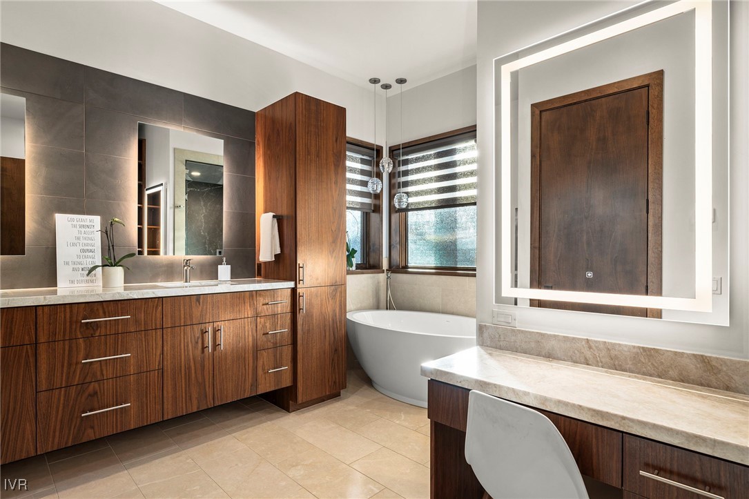823 Ellen Court Incline Village, NV 89451 - Photo 27 of 45 a bathroom with a granite countertop sink mirror and a bathtub