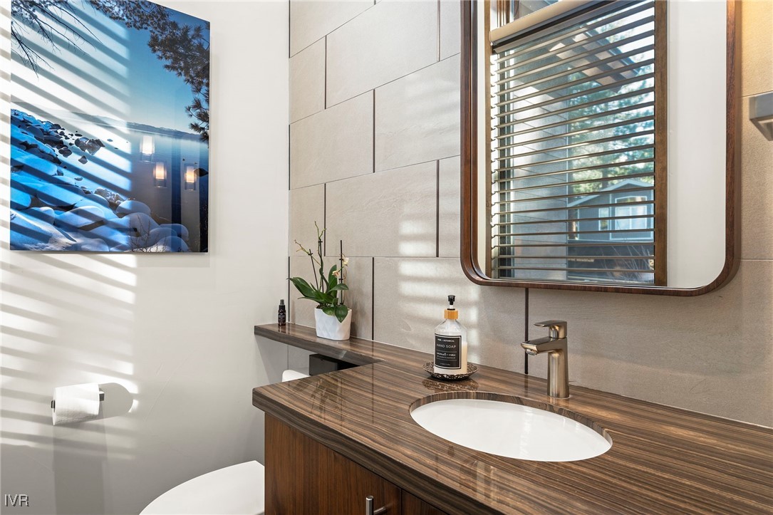 823 Ellen Court Incline Village, NV 89451 - Photo 30 of 45 a bathroom with a granite countertop sink and a mirror