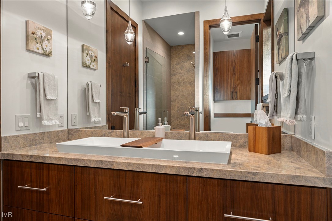 823 Ellen Court Incline Village, NV 89451 - Photo 34 of 45 a bathroom with a granite countertop sink and a mirror