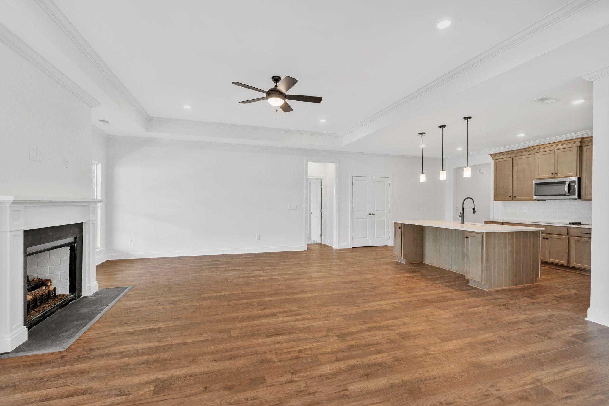 7505 Shoal Mill Point Fairview, TN 37062 - Photo 12 of 55 a view of a kitchen with a sink and a fireplace