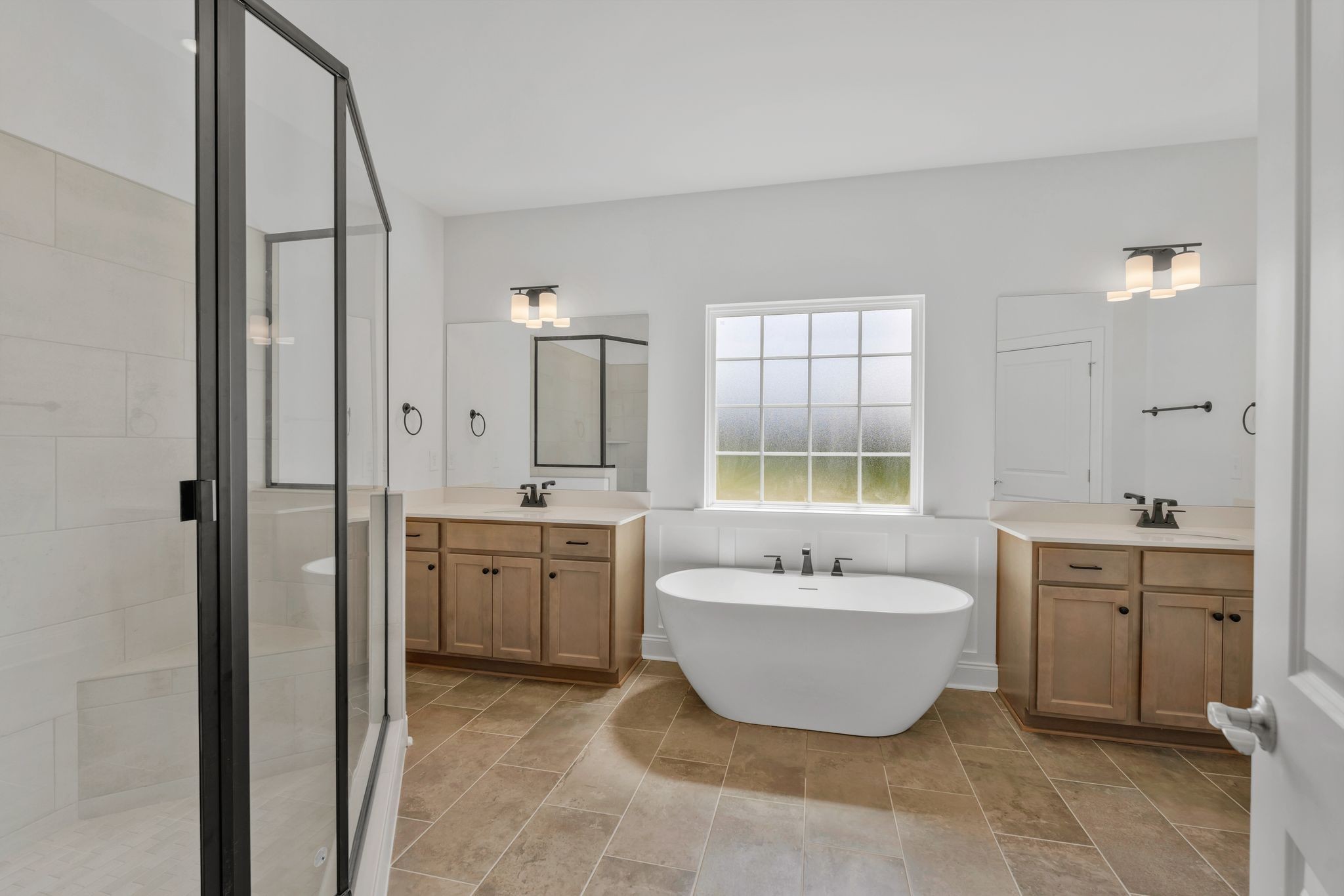 7505 Shoal Mill Point Fairview, TN 37062 - Photo 14 of 55 a spacious bathroom with a bathtub sink and mirror