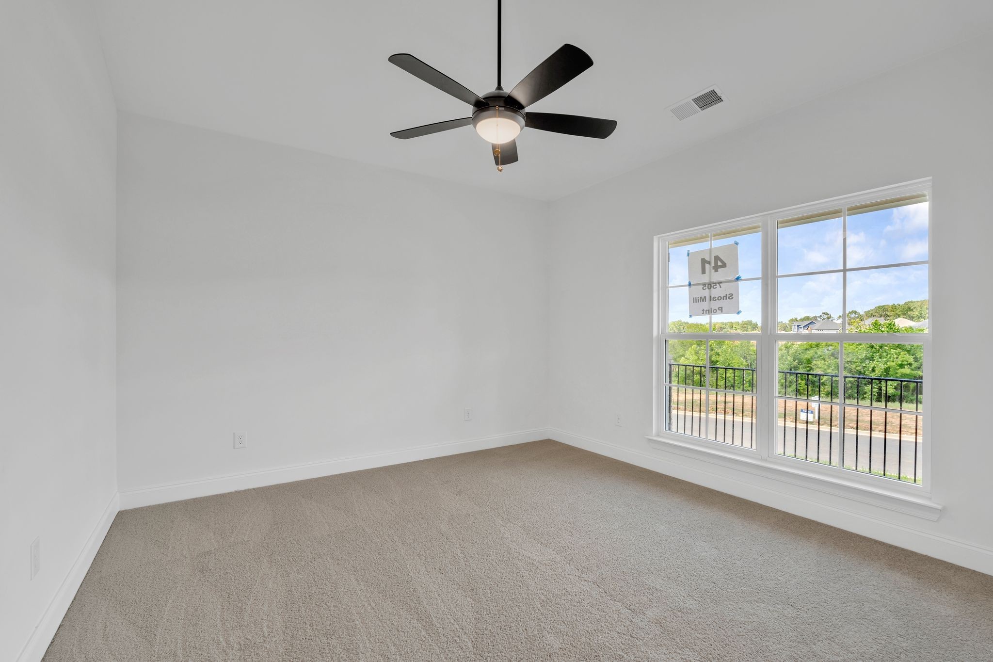 7505 Shoal Mill Point Fairview, TN 37062 - Photo 26 of 55 an empty room with windows and ceiling fan