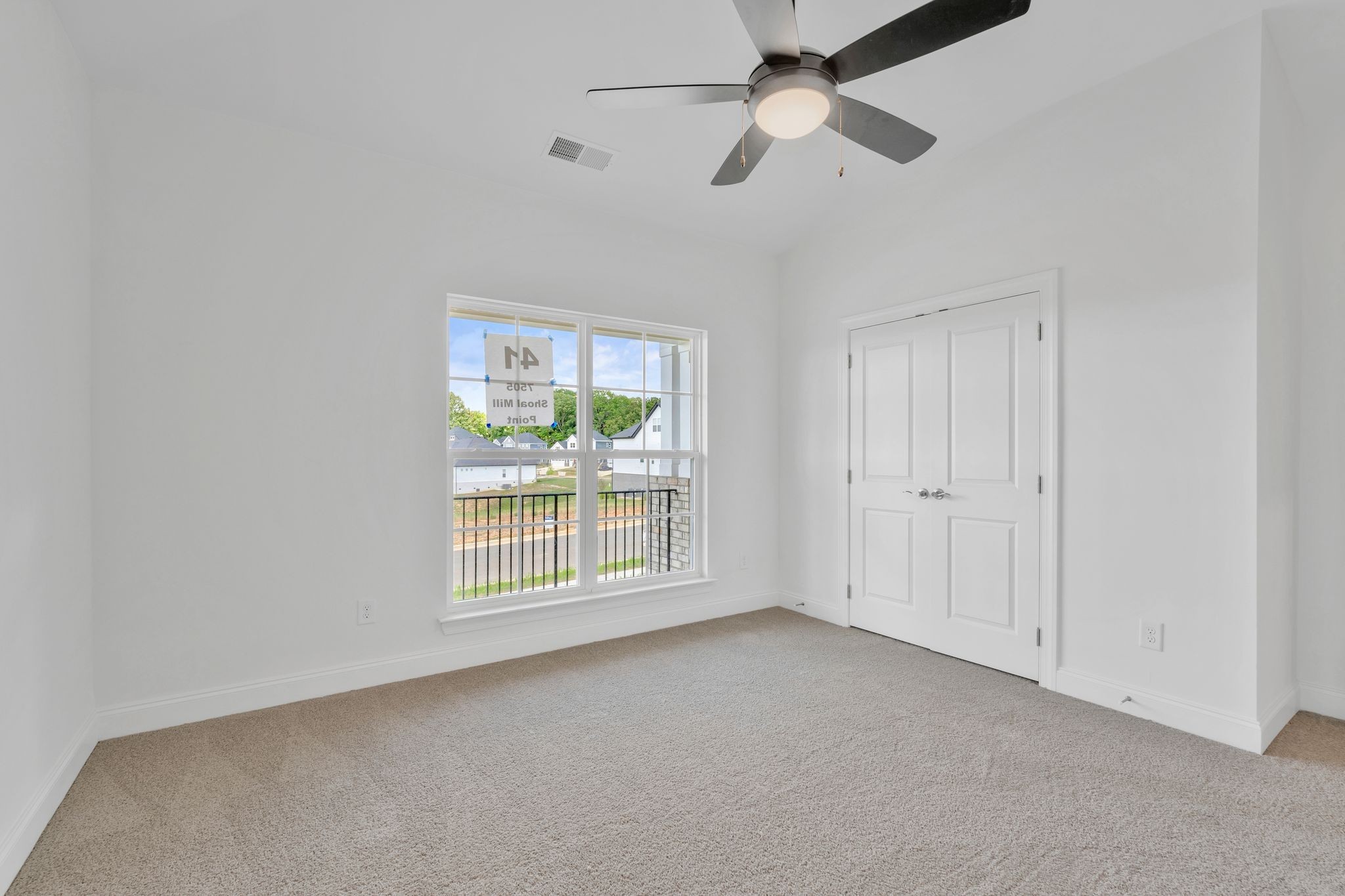 7505 Shoal Mill Point Fairview, TN 37062 - Photo 27 of 55 an empty room with chandelier fan and windows
