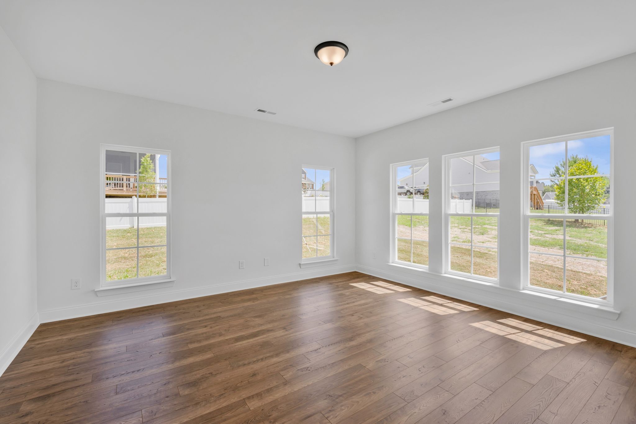 7505 Shoal Mill Point Fairview, TN 37062 - Photo 37 of 55 a view of an empty room with wooden floor and a window