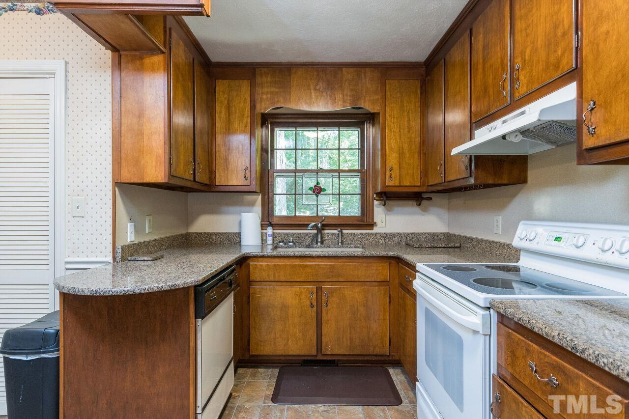 4215 Jane Lane Raleigh, NC 27604 - Photo 11 of 32 a kitchen with stainless steel appliances granite countertop a sink stove and cabinets