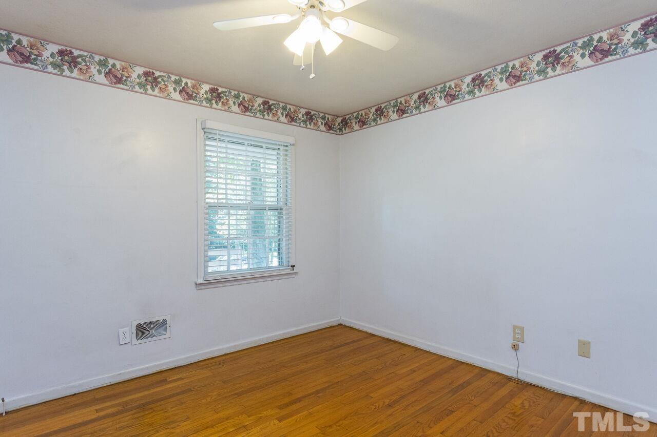 4215 Jane Lane Raleigh, NC 27604 - Photo 15 of 32 a view of an empty room with a window and wooden floor