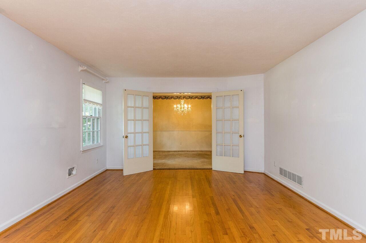 4215 Jane Lane Raleigh, NC 27604 - Photo 5 of 32 an empty room with wooden floor and windows