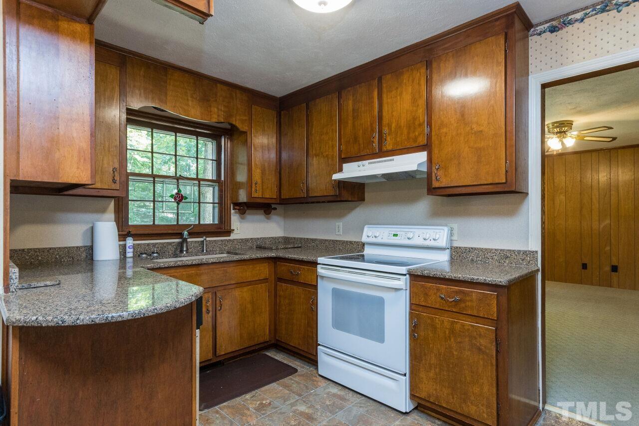 4215 Jane Lane Raleigh, NC 27604 - Photo 10 of 32 a kitchen with a sink stove and cabinets