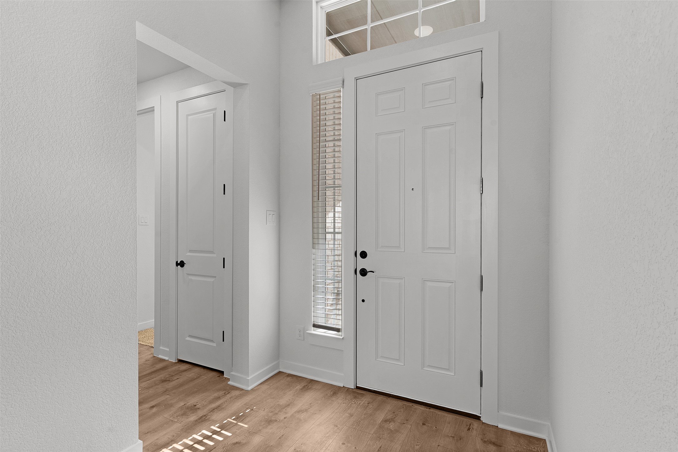 328 Ridgewell Loop Georgetown, TX 78633 - Photo 4 of 28 Entryway with a textured wall and light wood finished floors