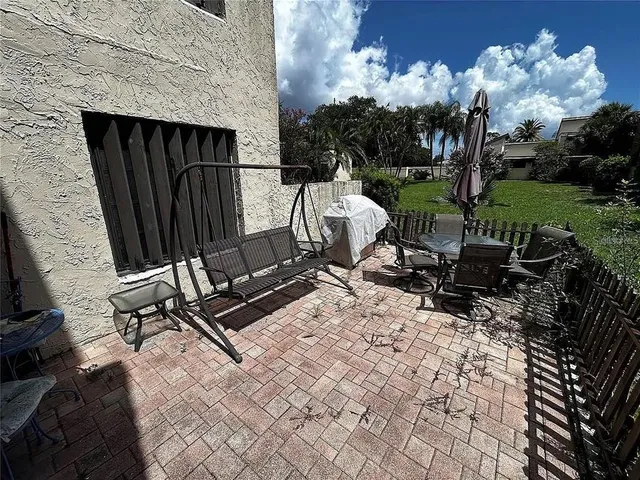 a view of a backyard with chairs and a grill