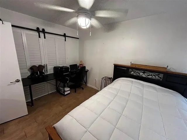 a bedroom with a bed and a chandelier