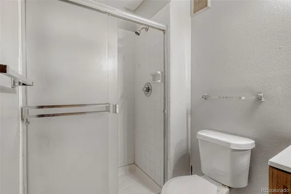 a bathroom with a shower and a toilet