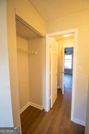 a view of hallway with wooden floor
