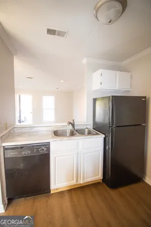 a kitchen with a sink a refrigerator and a stove