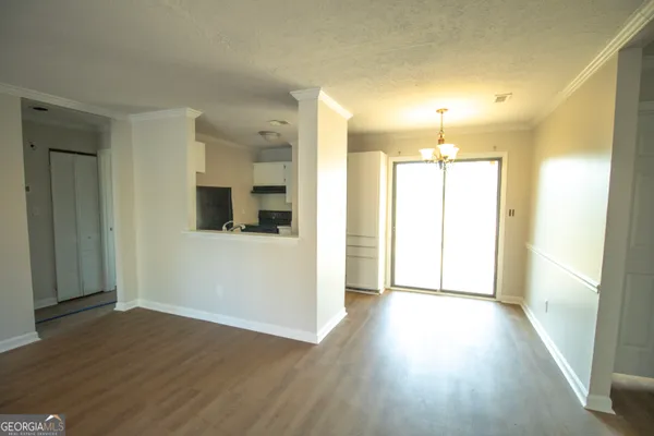 a view of a hallway with wooden floor