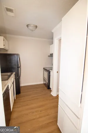 a view of a kitchen from the hallway