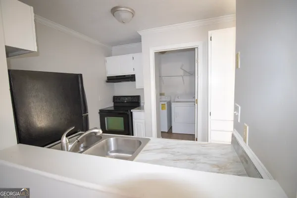 a kitchen with a refrigerator and a sink
