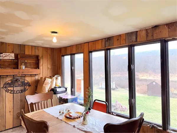 a view of a a dining room with furniture window and outside view