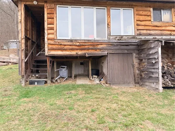 a view of a house with a wooden fence
