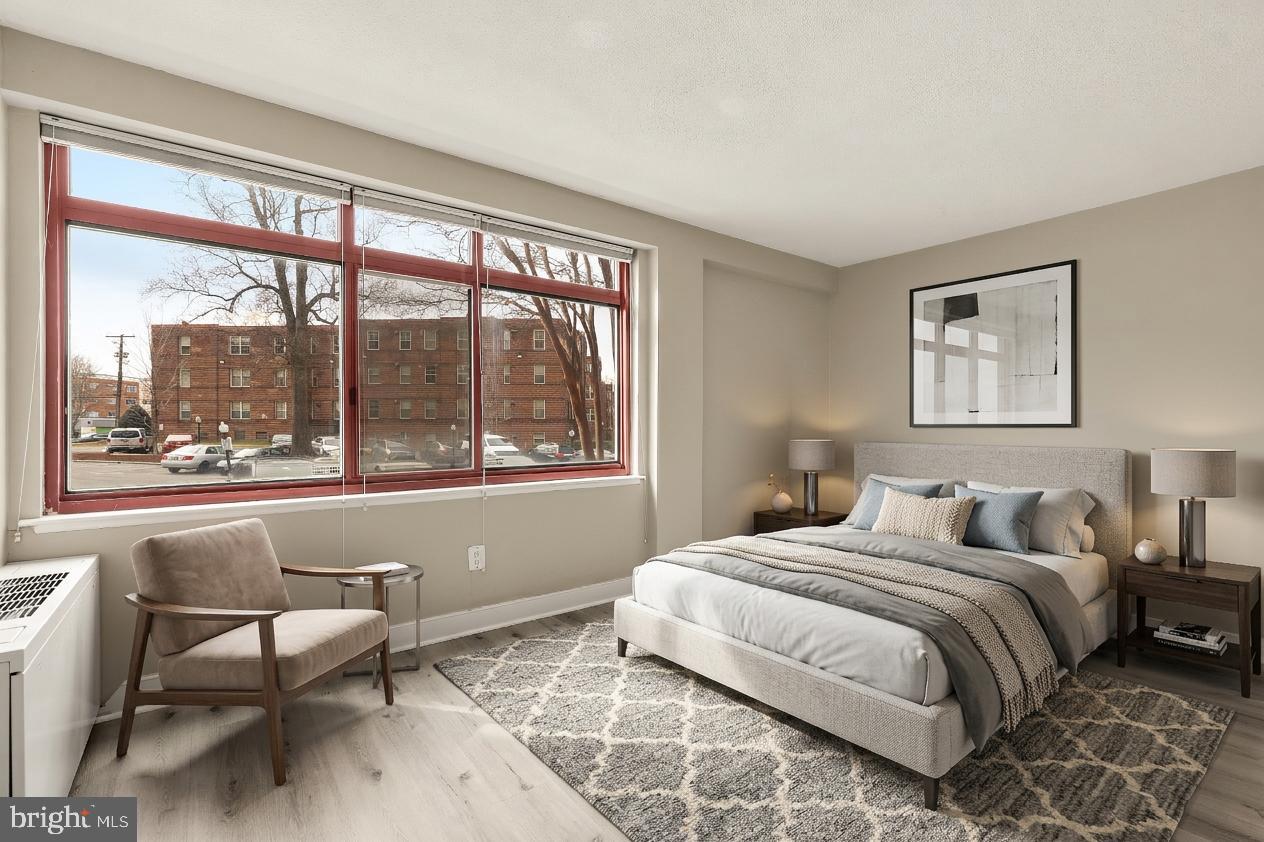 1220 Blair Mill Road, Unit 101 Silver Spring, MD 20910 - Photo 14 of 26 a bedroom with a bed and a large window