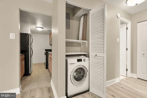 a view of a hallway with washer and dryer