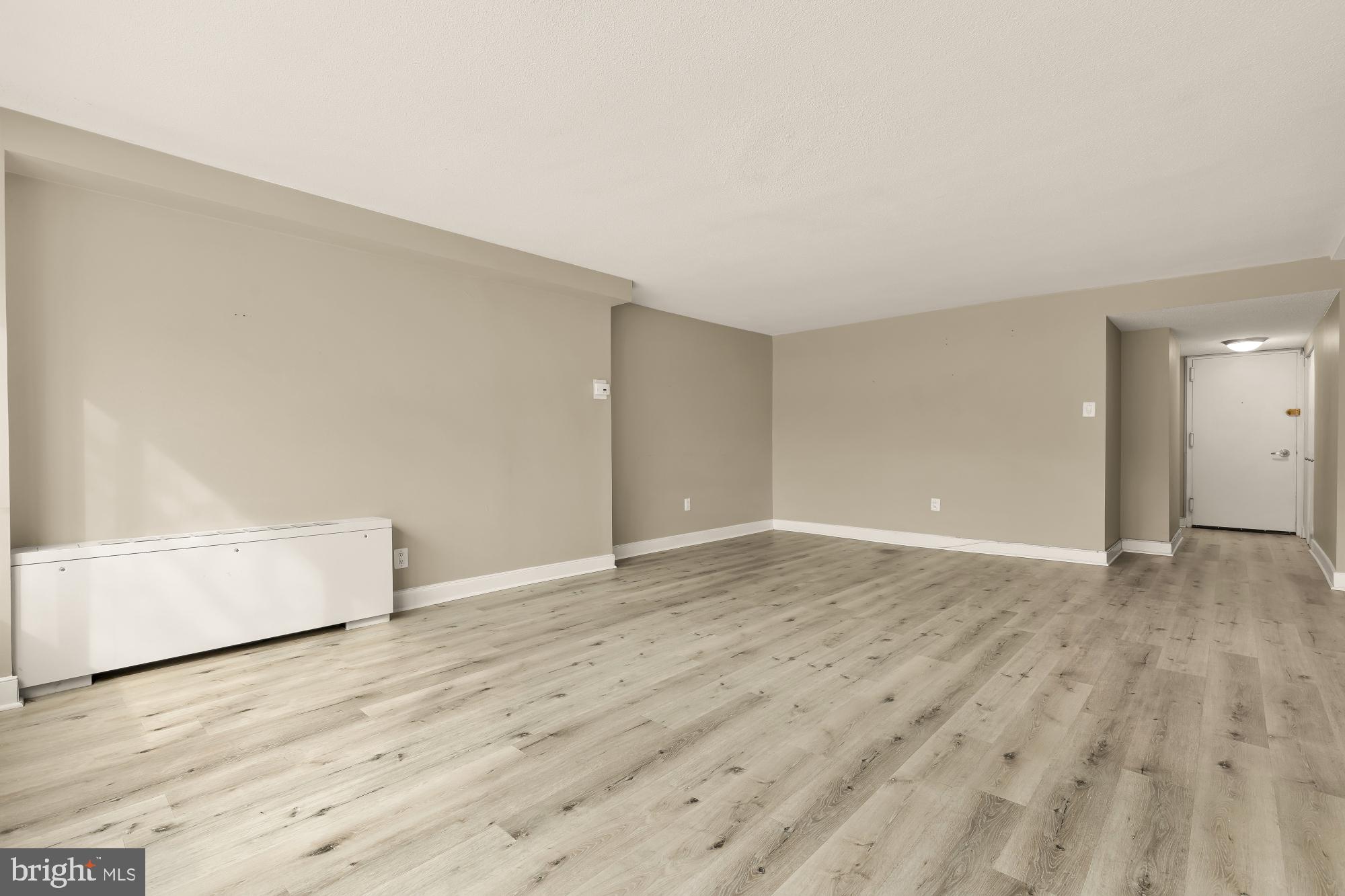 1220 Blair Mill Road, Unit 101 Silver Spring, MD 20910 - Photo 5 of 26 wooden floor in an empty room