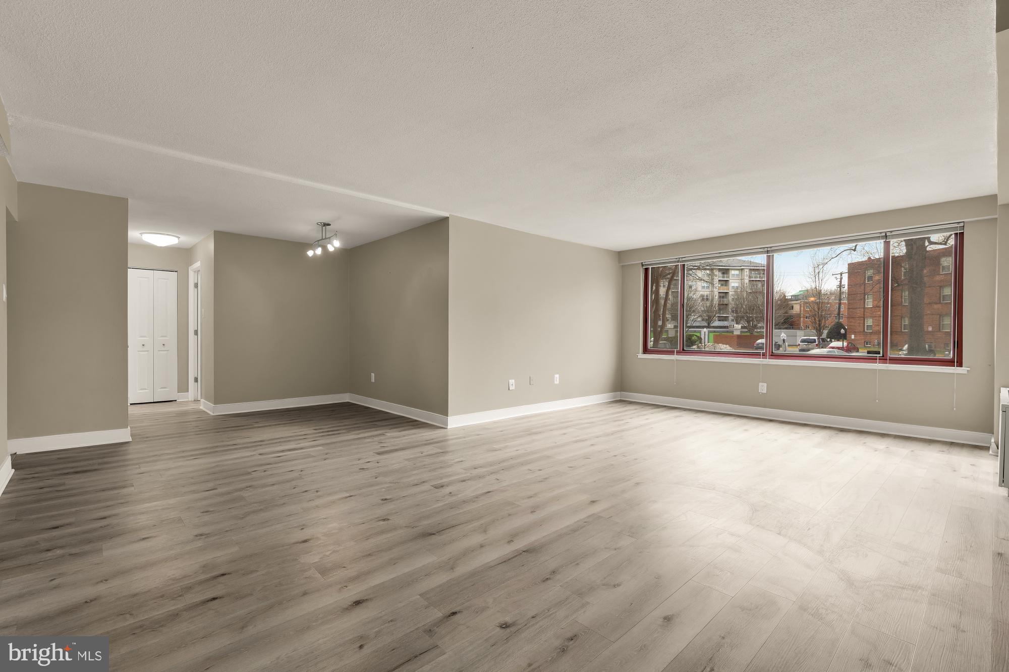 1220 Blair Mill Road, Unit 101 Silver Spring, MD 20910 - Photo 7 of 26 a view of an empty room with wooden floor and a window