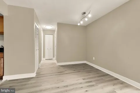 a view of an empty room with wooden floor
