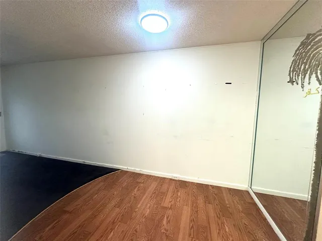 an empty room with wooden floor