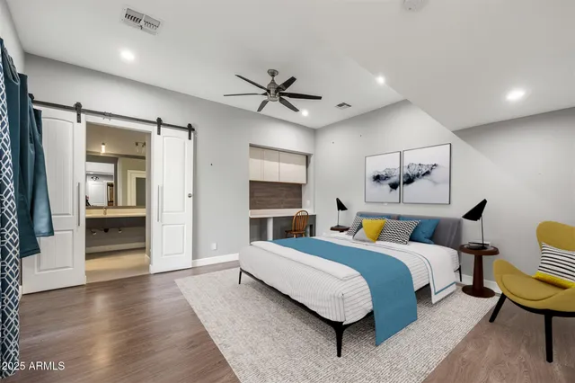 a bathroom with a granite countertop sink a mirror and a shower