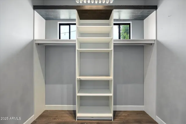 a hallway with wooden floor and furniture