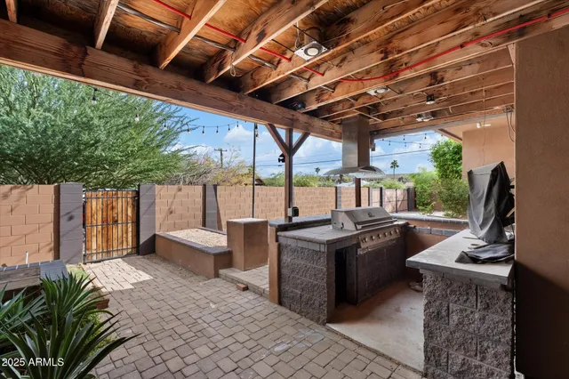 a view of a patio with table and chairs potted plants