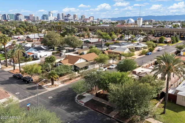 a front view of a house with a yard and tree
